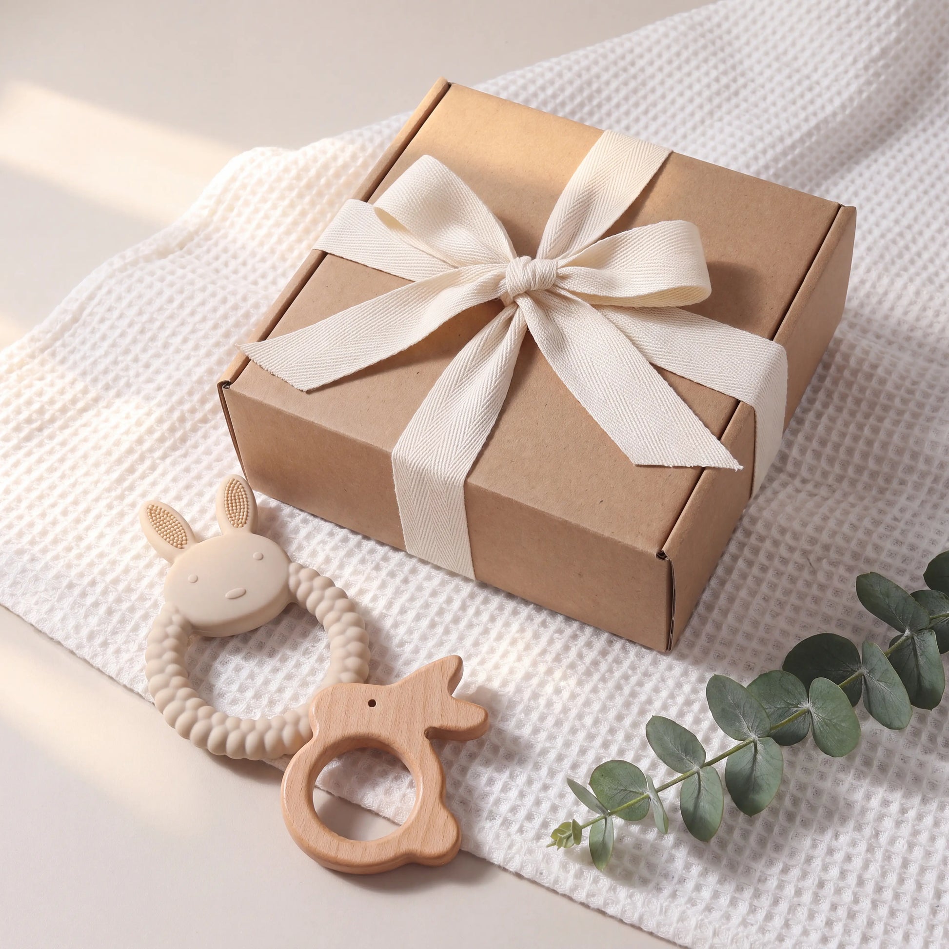 Rahaya teether gift set — ribbon-tied gift box scene