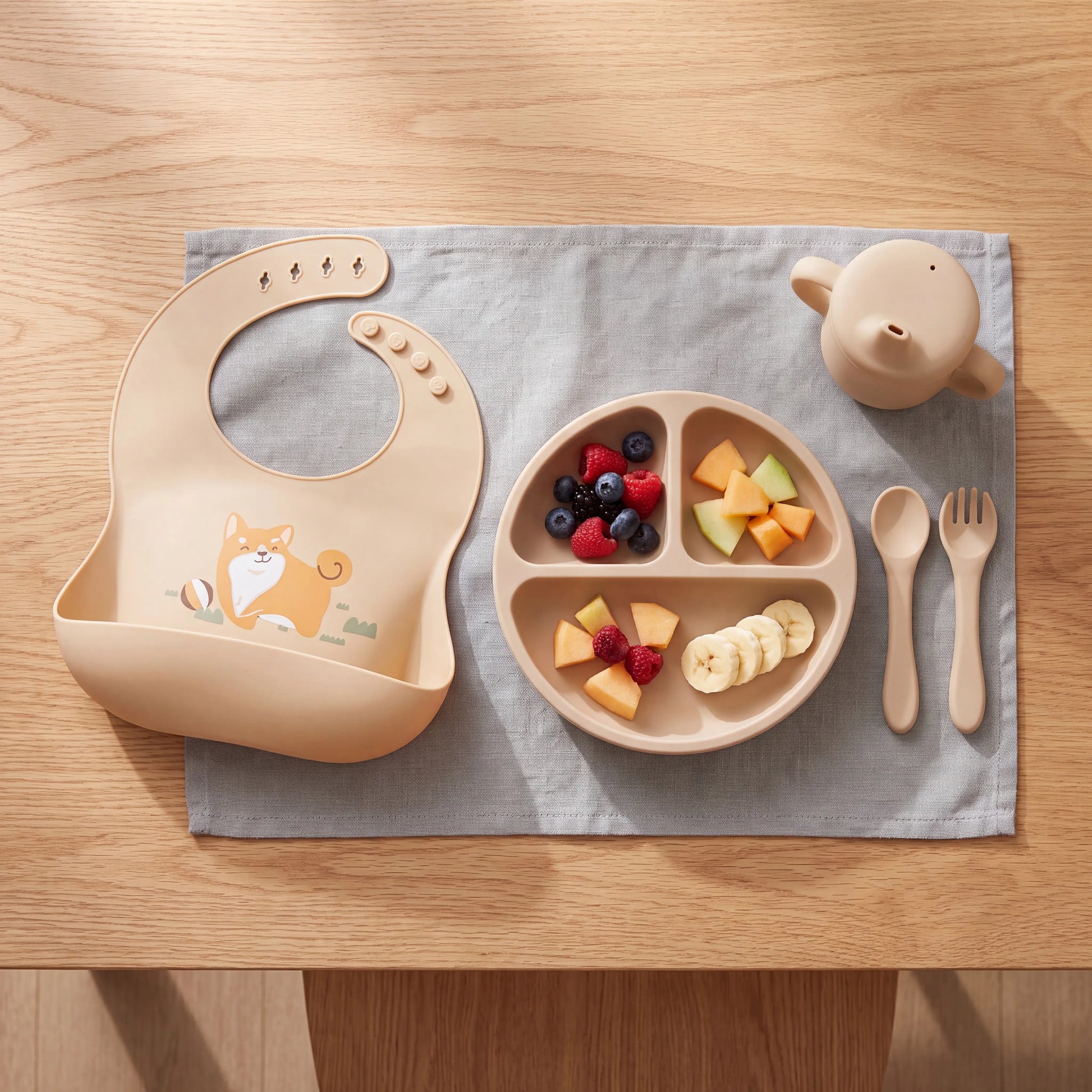 Rahaya bib mealtime flat lay with plate and cutlery